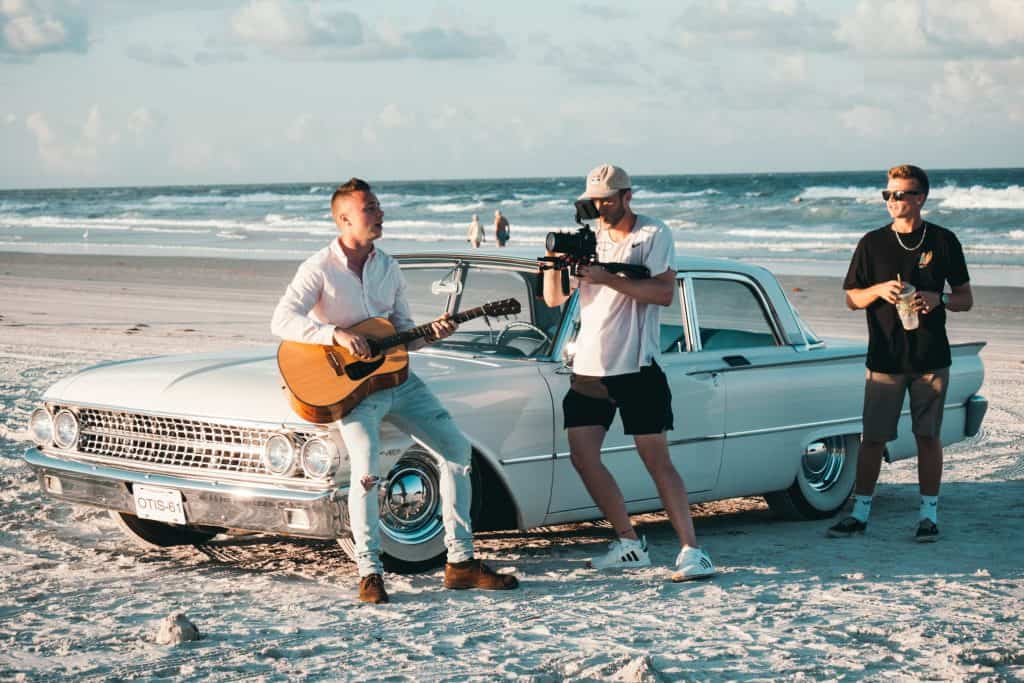 recording guitar music video at beach